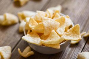 homemade crunchy prawn crackers or shrimp crisp rice - prawn crackers chips on white bowl and wooden table background photo