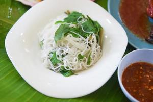 thai rice noodles and vegetable on white plate with spicy chili sauce - Thai food vermicelli noodle photo