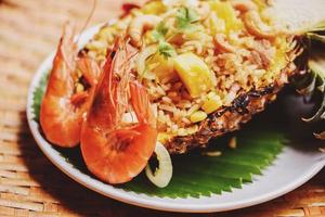 delicious menu shrimps prawns cooked - fried rice shrimp and fruits pineapple on plate asian food in thai photo