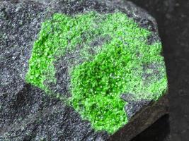 crystals of Uvarovite on rock close up photo