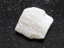 raw Gypsum stone on dark background photo