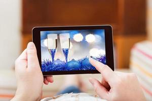 man touches tablet-pc with blue Xmas still life photo