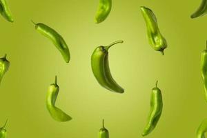 Creative image of green peppers flying on green background. Photo of fresh peppers with copy space.