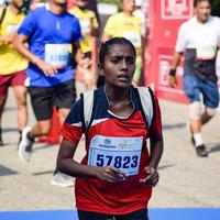 New Delhi, India - October 16 2022 - Vedanta Delhi Half Marathon race after covid in which marathon participants about to cross the finish line, Delhi Half Marathon 2022 photo