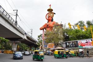 New Delhi, India - June 21, 2022 - Big statue of Lord Hanuman near the delhi metro bridge situated near Karol Bagh, Delhi, India, Lord Hanuman big statue touching sky photo