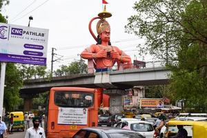 New Delhi, India - June 21, 2022 - Big statue of Lord Hanuman near the delhi metro bridge situated near Karol Bagh, Delhi, India, Lord Hanuman big statue touching sky photo