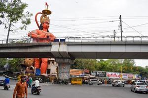 New Delhi, India - June 21, 2022 - Big statue of Lord Hanuman near the delhi metro bridge situated near Karol Bagh, Delhi, India, Lord Hanuman big statue touching sky photo