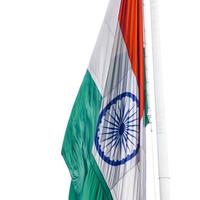 India flag flying high at Connaught Place with pride in blue sky, India flag fluttering, Indian Flag on Independence Day and Republic Day of India, tilt up shot, Waving Indian flag, Har Ghar Tiranga photo