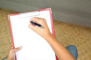 Detail close up of psychologist taking notes photo