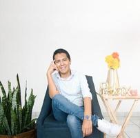 happy male psychologist sitting in his office photo