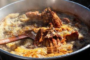 Saucepan with pork carnitas frying in lard in Mexico photo