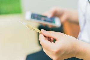 people typing credit card number in smartphone app for online shopping  payment or mobile internet banking photo