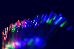 colors laser fiber optic cable communication tech background. photo