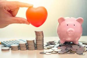 Love Heart and Saving Money Piggy Bank for Life insurance Share or Donation concept. photo
