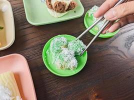 traditional Indonesian snack food. klepon eaten using chopsticks, cutlery from Japan photo