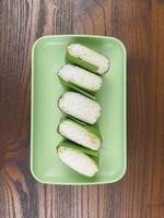 traditional snack food from Indonesia. lemper made from rice and in containing slices of chicken meat wrapped in banana leaves photo