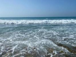 Beautiful sea with waves splashing water landscape view from the beach in a warm tropical eastern country southern resort. Background, texture photo