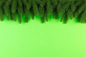 Top view of colorful festive background made of fir tree branch. Christmas holiday concept with copy space photo