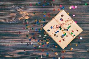 Simple christmas gift with red twine and decor stars. Toned photo