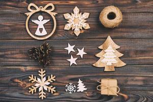 Christmas composition. Christmas snowflakes, Christmas tree and angel in a frame on a wooden background. New Year wooden vintage decorations photo