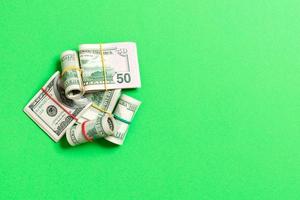 Stacks of one hundred dollars banknotes close-up on colored background business concept top view with copy space photo