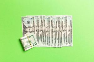 Top view of lying 20 dollar banknotes in one line on colorful background. Close up of money saving concept photo