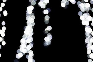 Abstract bokeh of white city lights on black background. defocused and blurred many round light photo