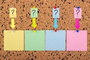 A sticker with a question mark is attached to the cork board. Empty stickers for copy space. photo