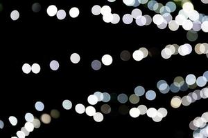 Abstract bokeh of white city lights on black background. defocused and blurred many round light photo