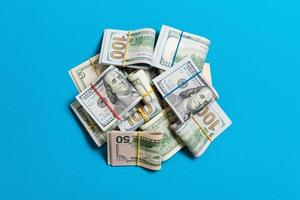 Many Stack of 100 dollar bills. Isolated on colored background top wiev with copy space photo