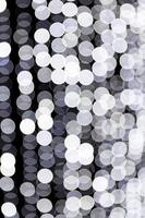 Abstract bokeh of white city lights on black background. defocused and blurred many round light photo