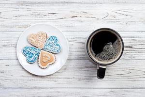 Cup of coffee and cookies on rustic wooden table photo