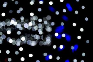 Abstract bokeh of white city lights on black background. defocused and blurred many round light photo