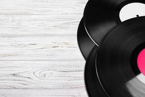 Old vinyl record on the bright wooden table, selective focus and toned image. Copy space photo