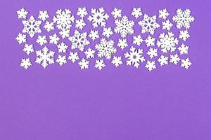 Top view of winter ornament made of white snowflakes on colorful background. Happy New Year concept with copy space photo