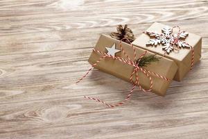 Christmas gift boxes on wooden table with snowflake. Top view with copy space photo
