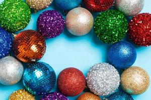 Top view of frame made of decorative balls on colorful background. Christmas toys concept with empty space for your design photo