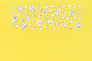 Top view of white snowflakes on colorful background. Winter weather concept with copy space. Merry Christmas concept photo