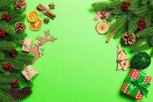 Top view of Christmas decorations on green background. New Year holiday concept with copy space photo