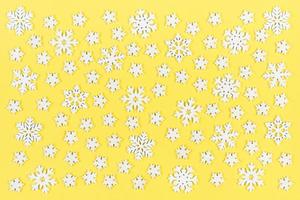 Top view of white snowflakes on colorful background. Winter weather concept with copy space. Merry Christmas concept photo