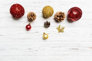 Top view of festive winter composition on wooden background with empty space for your design. Christmas baubles and decorations. New Year concept photo