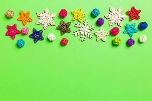 New Year decorations on green background. Festive stars and balls. Merry Christmas concept with empty space for your design photo
