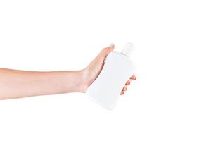 Female hand holding cream bottle of lotion isolated. Girl give cosmetic products on white background photo