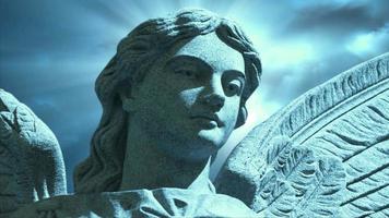 The statue of an Angel on time lapse blue clouds - Loop