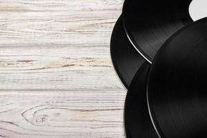 Vinyl records on light white wooden background photo