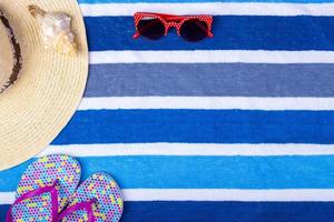 Straw Beach Woman's Hat Sun Glasses Top View Seashell Flip flops with space for text. photo