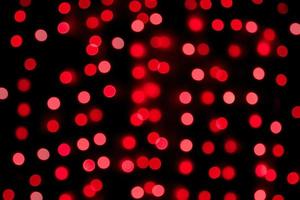 Unfocused abstract red bokeh on black background. defocused and blurred many round light photo