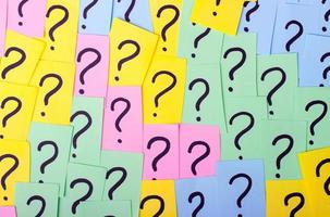 Too Many Questions. Pile of colorful paper notes with question marks. Closeup. photo