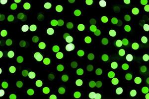 Unfocused abstract colourful bokeh black background. defocused and blurred many round green light photo