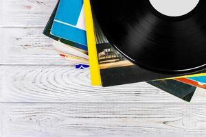 old records stack. vintage on wooden background photo